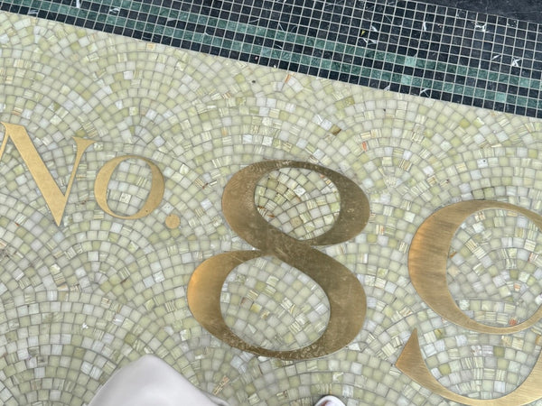 Jade green marble fan mosaic with gold metal house numbers