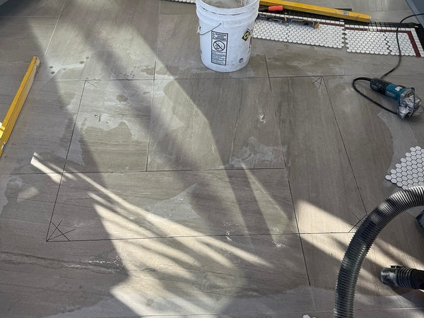 Existing floor marked and cut out for a mosaic logo inlay
