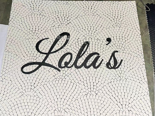 Script lettering mosaic laid out at the factory before shipping