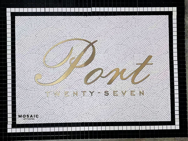 Custom mosaic with gold stainless steel script lettering set into tile