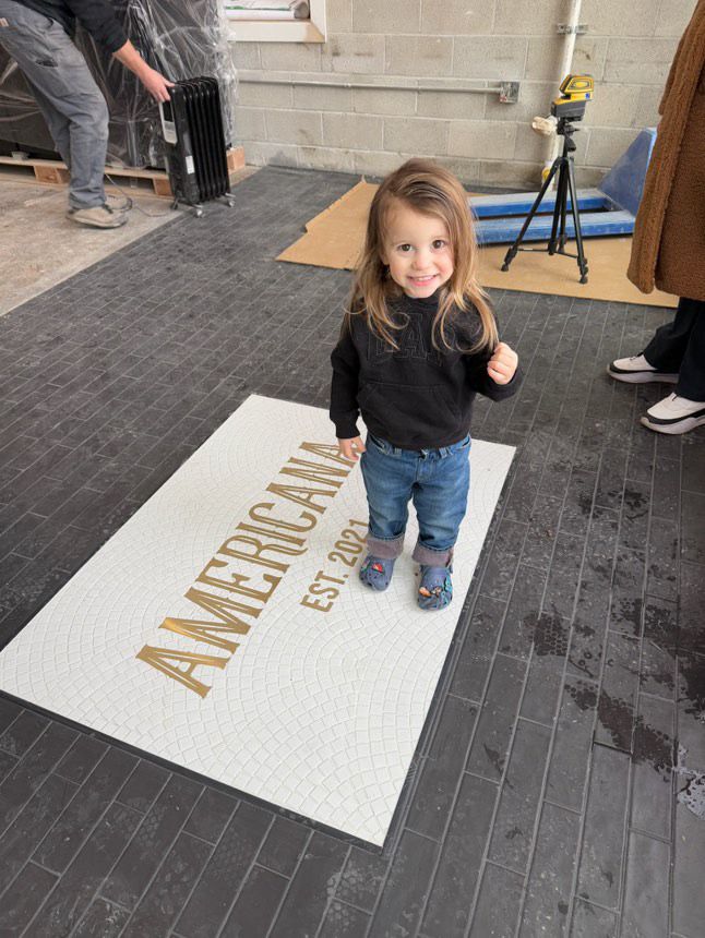 Americana gold lettering mosaic with happy visitor, restaurant logo mosaic by Mosaic Lettering