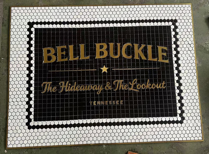 Bell Buckle gold lettering on black mosaic, bar logo mosaic by Mosaic Lettering, photographed at our studio before installation