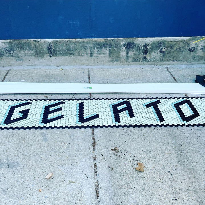 GELATO black and white threshold lettering, restaurant logo mosaic by Mosaic Lettering, photographed at our studio before installation
