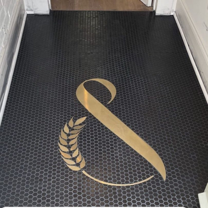 Gold ampersand on black hexagon, bar logo mosaic by Mosaic Lettering