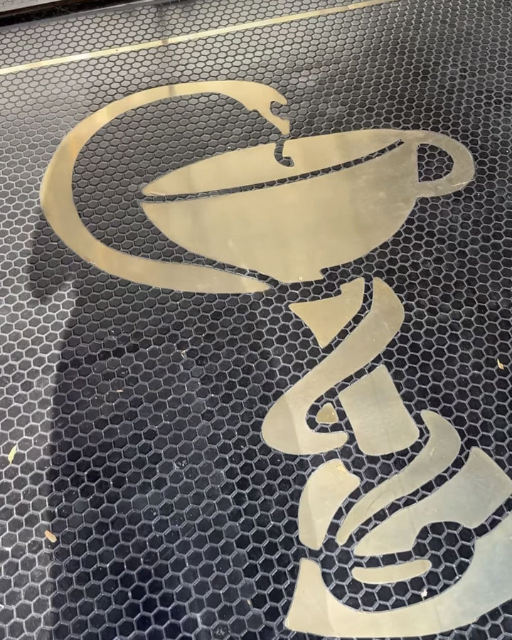 Gold coffee cup on black mosaic, restaurant logo mosaic by Mosaic Lettering