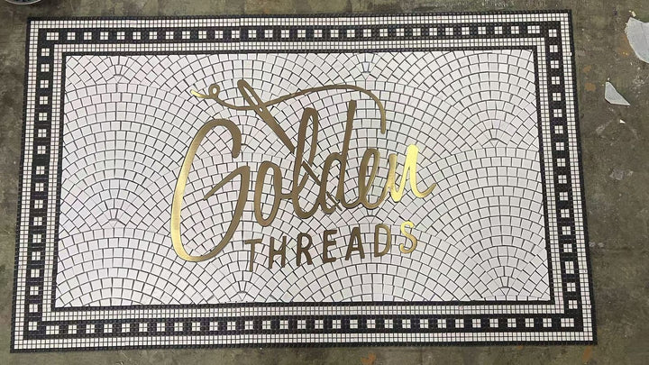 Golden Threads gold script mosaic, business logo mosaic by Mosaic Lettering, photographed at our studio before installation