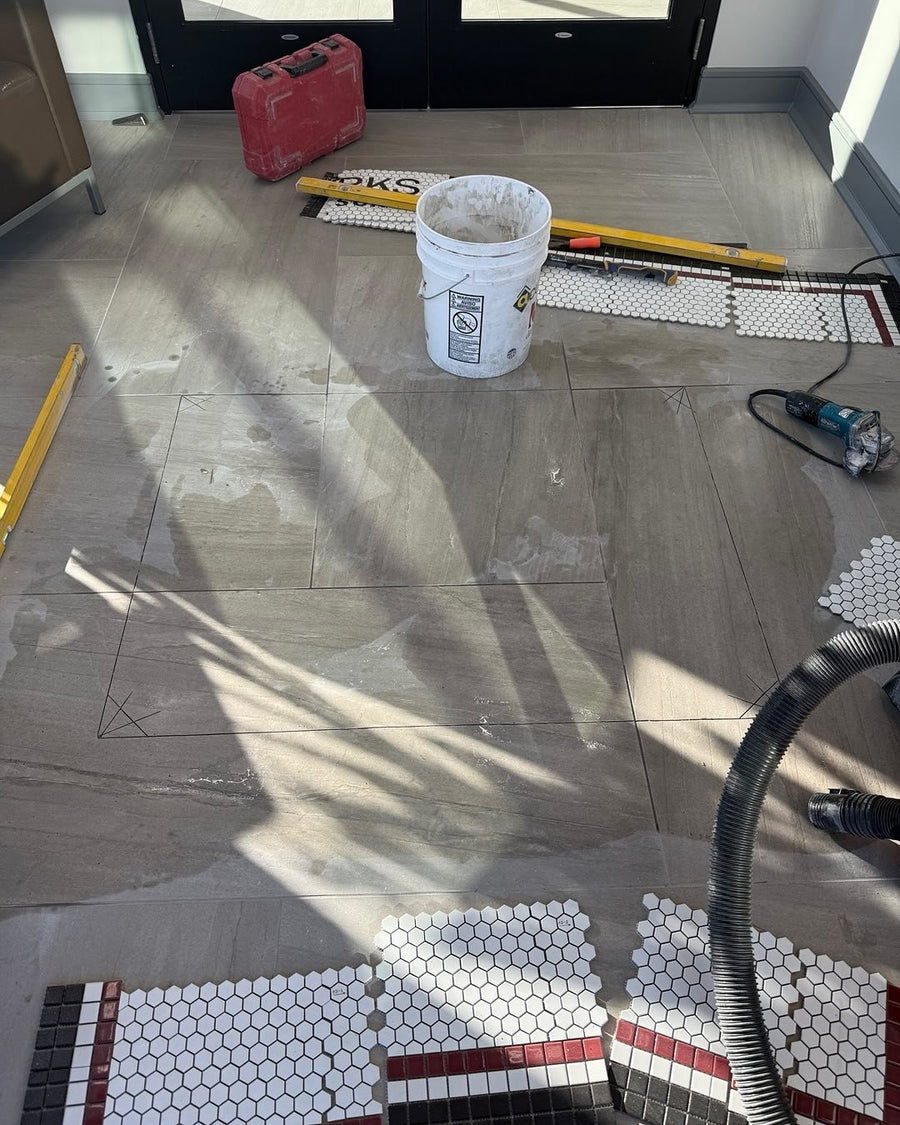 Floor tiles marked and cut out where the mosaic will be inset