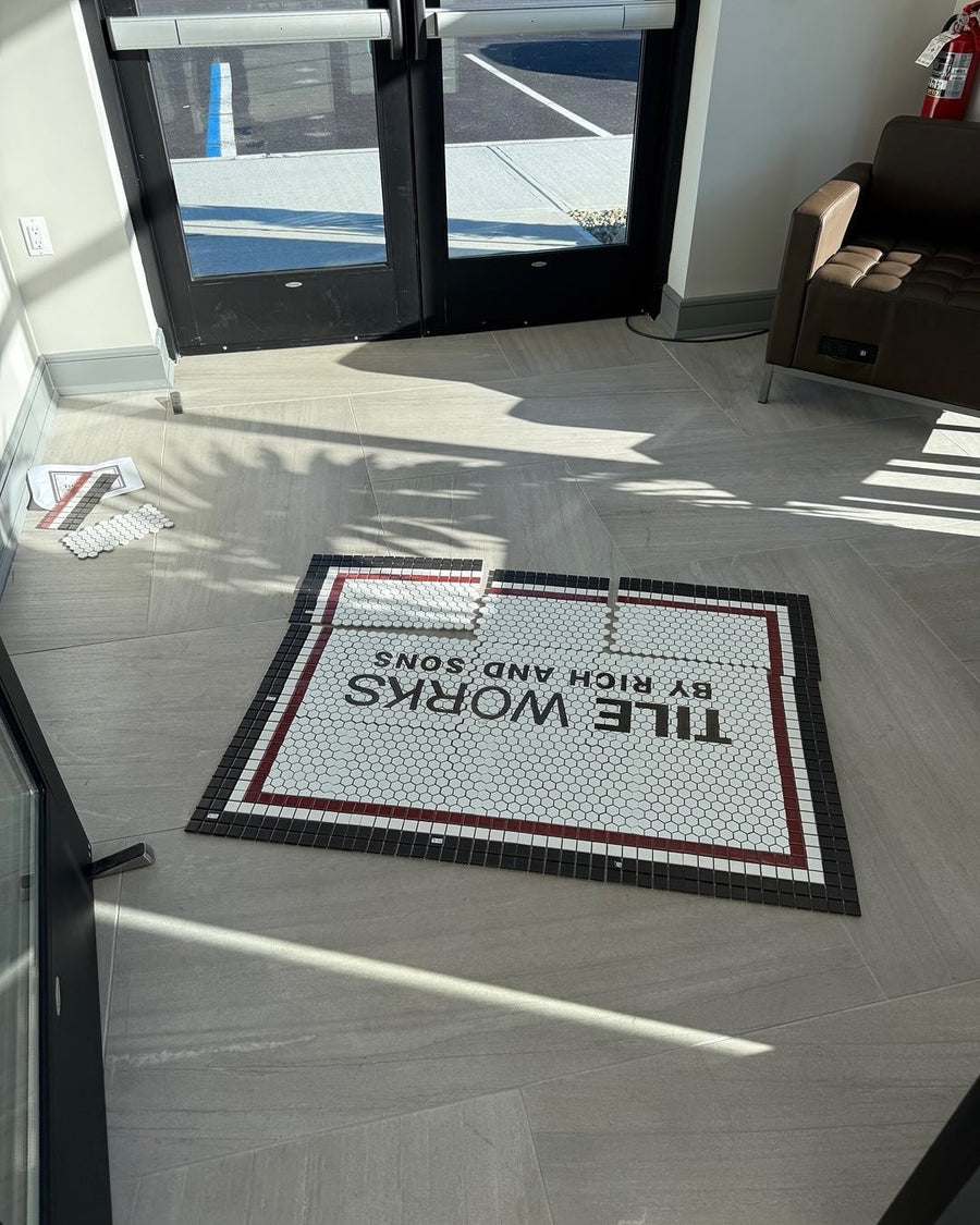 Tile Works mosaic laid out dry on numbered mesh sheets at a shop entrance