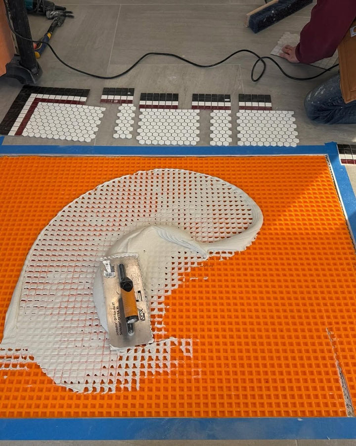 Installing a mosaic on site, business logo mosaic by Mosaic Lettering, photographed at our studio before installation