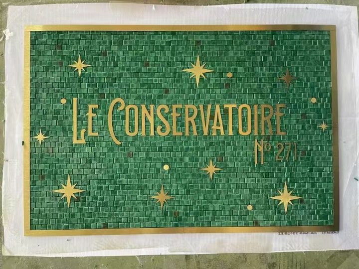 Le Conservatoire green mosaic with gold stars, restaurant logo mosaic by Mosaic Lettering, photographed at our studio before installation