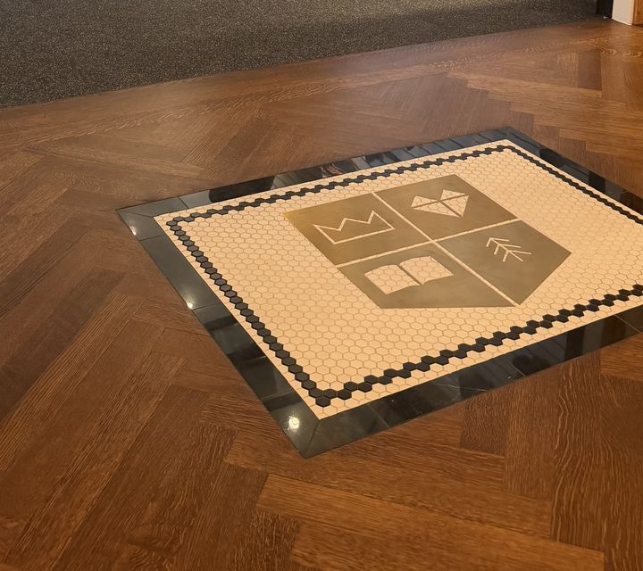 Logo mosaic in shop floor, business logo mosaic by Mosaic Lettering
