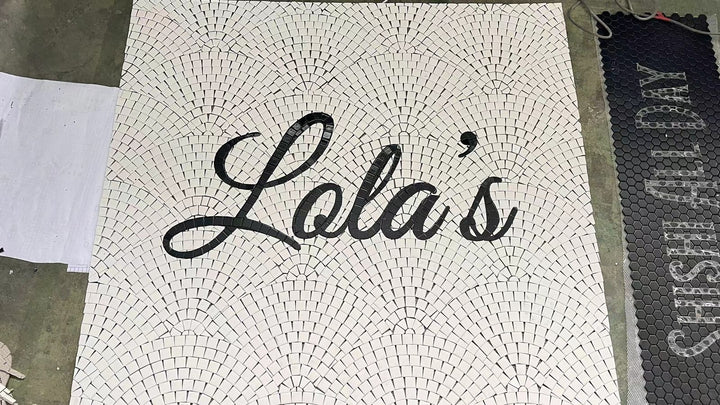 Lola's script mosaic laid out at the factory, restaurant logo mosaic by Mosaic Lettering, photographed at our studio before installation