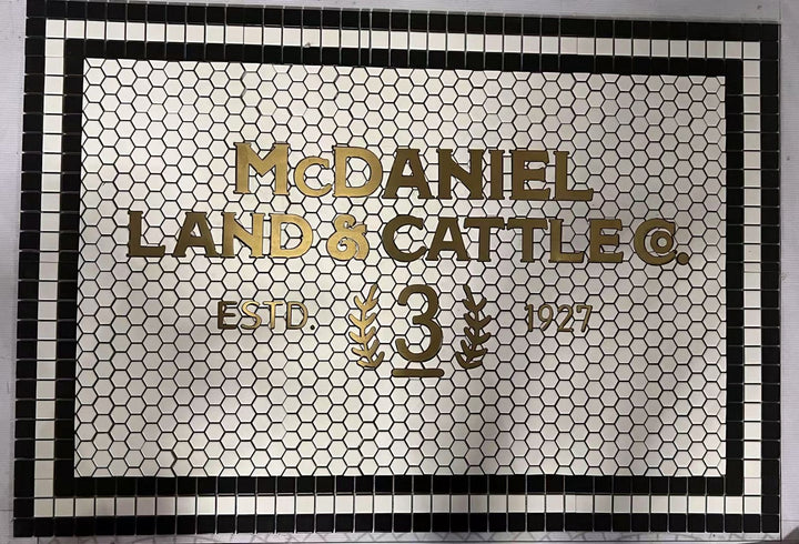 McDaniel Land & Cattle Co. mosaic, business logo mosaic by Mosaic Lettering, photographed at our studio before installation