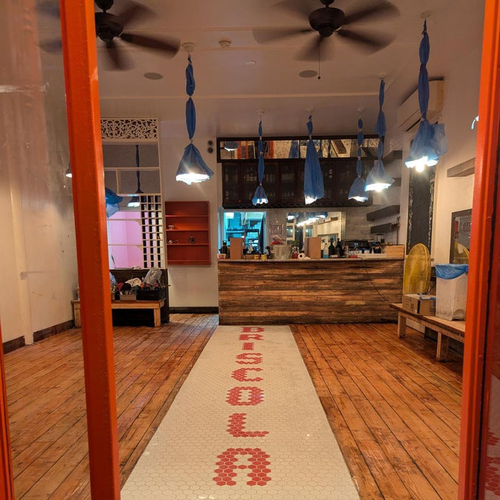 Mosaic installation in progress, restaurant floor, restaurant logo mosaic by Mosaic Lettering