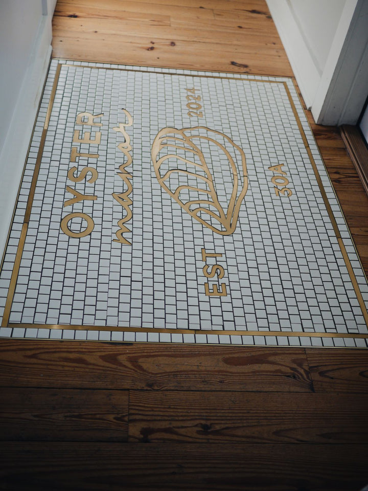 Oyster Manor mosaic being installed, restaurant logo mosaic by Mosaic Lettering
