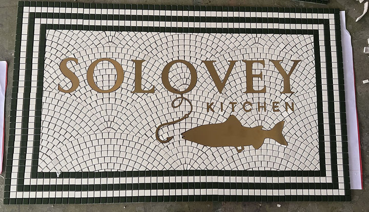 Solovey Kitchen fish logo mosaic, restaurant logo mosaic by Mosaic Lettering, photographed at our studio before installation