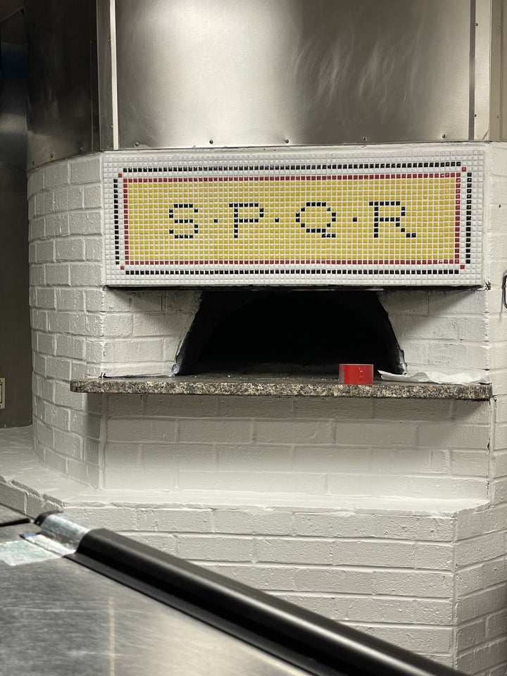 SPQR lettering mosaic on pizza oven, restaurant logo mosaic by Mosaic Lettering