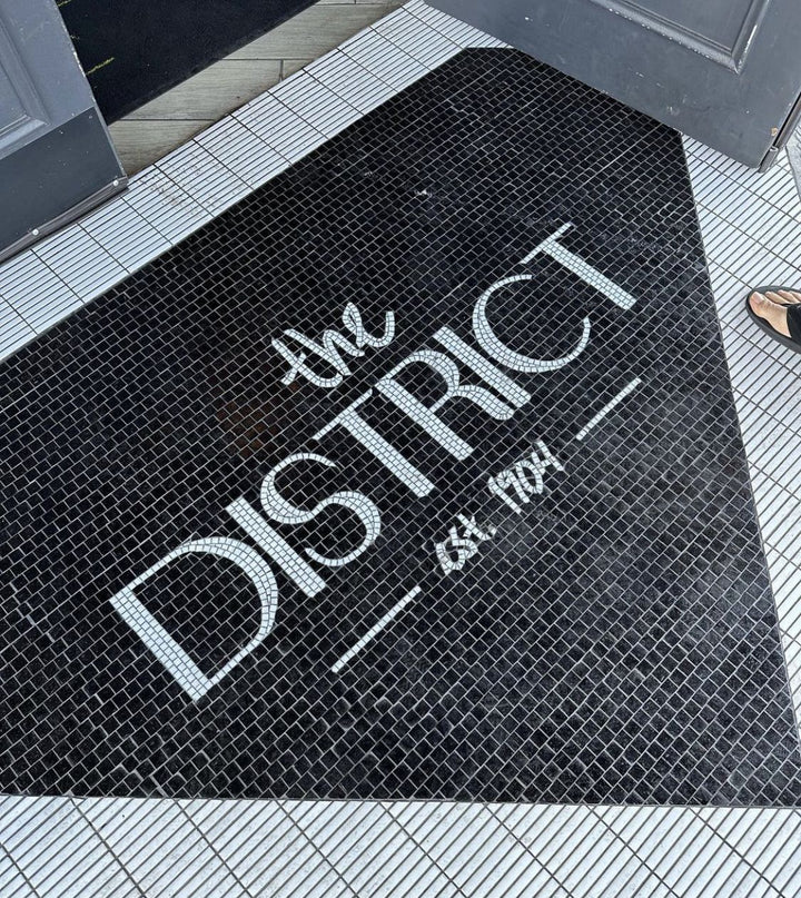 The District black script mosaic, business logo mosaic by Mosaic Lettering