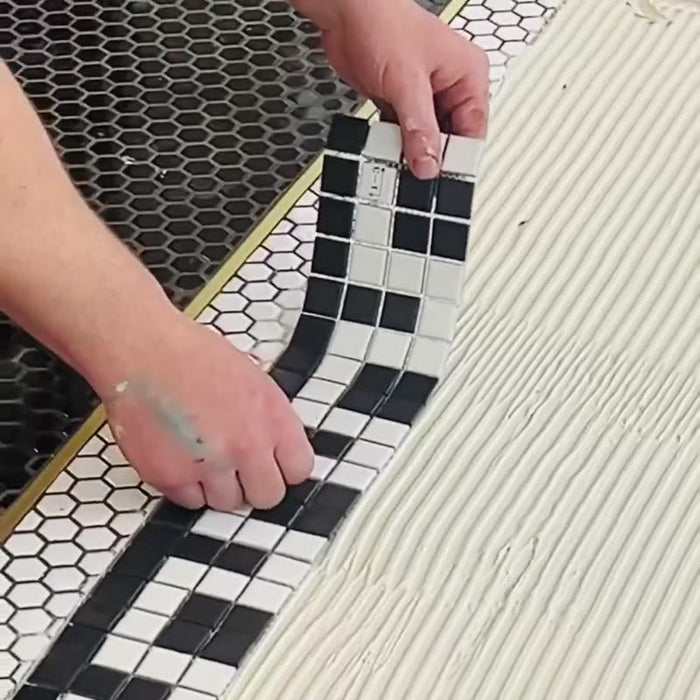 A hexagon lettering mosaic being installed